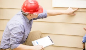 Trusted home inspectors in San Antonio inspecting exterior siding – A.I.M. For Real Estate Inspections TREC 5171